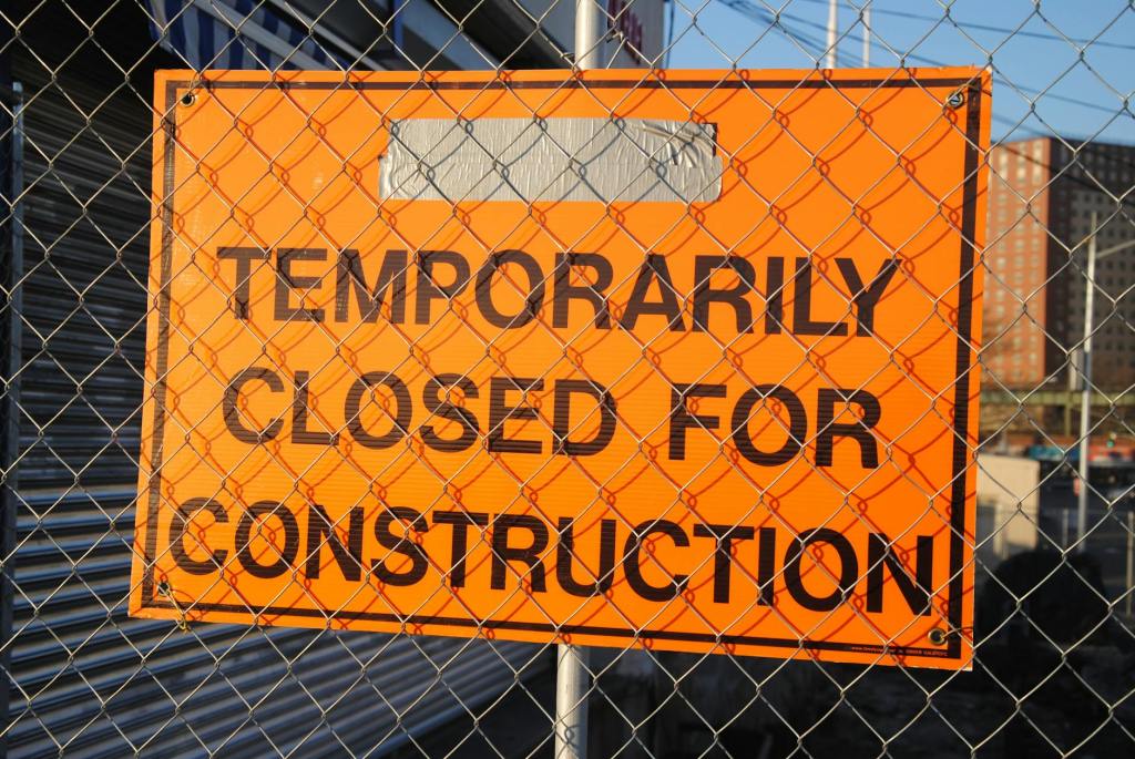 orange and black temporarily closed for construction signage