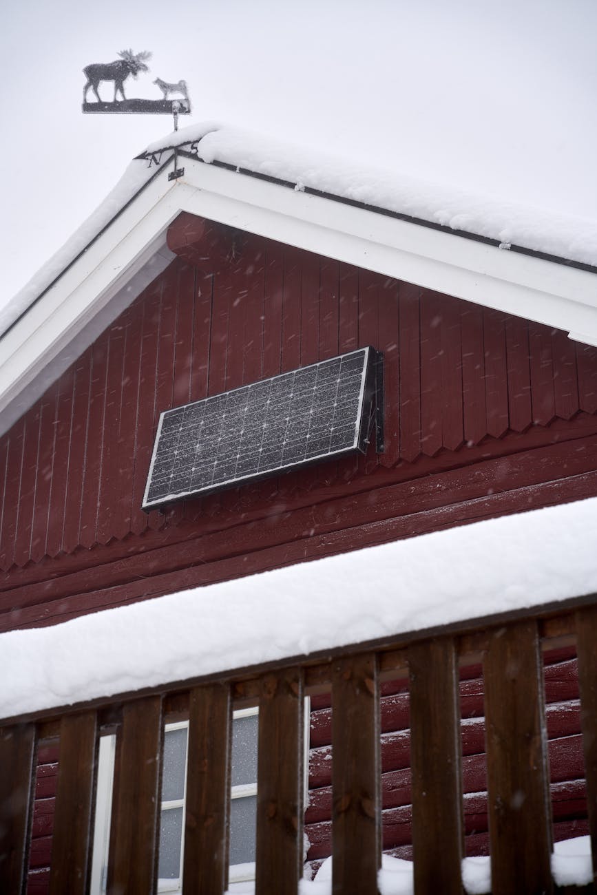 low angle shot of house with an installed solar panel in the winter